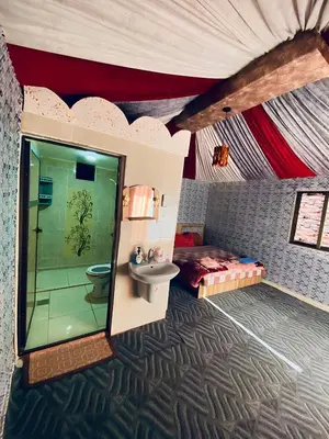 a bathroom with a sink and a bed in a tent at Nafa Rum Camp in Wadi Rum
