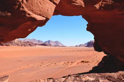 a window in a rock in the desert at Nafa Rum Camp in Wadi Rum
