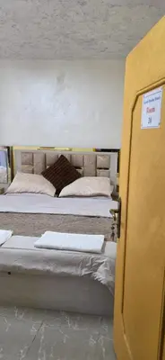 a room with three beds and a open door at hostel ـ Karak dream in Kerak