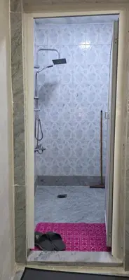 a shower with a glass door in a bathroom at hostel ـ Karak dream in Kerak