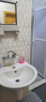 a bathroom with a white sink and a mirror at hostel ـ Karak dream in Kerak