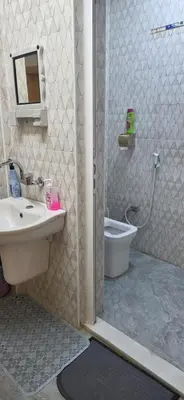 a bathroom with a shower with a sink and a toilet at hostel ـ Karak dream in Kerak