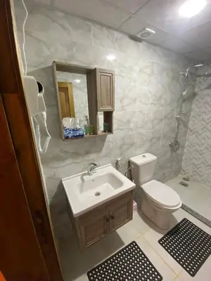a bathroom with a sink and a toilet and a mirror at Salma Desert Camp in Wadi Rum