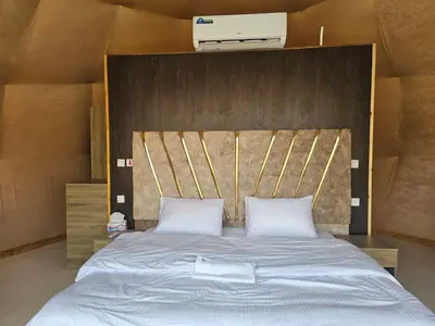 a large bed with two white pillows on it at Salma Desert Camp in Wadi Rum