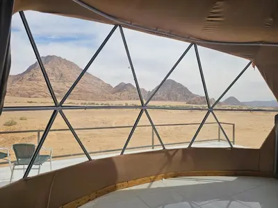 a view of the desert from the inside of a tent at Salma Desert Camp in Wadi Rum