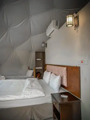a bedroom with a large bed and a table at Tower Rum Camb in Wadi Rum