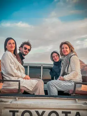 a group of people sitting in the back of a boat at Tower Rum Camb in Wadi Rum