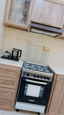 a kitchen with a stove top oven in a kitchen at lacasa chalet private With a panoramic view of the DeadSea in Sowayma