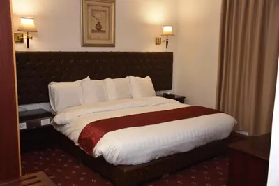 a bedroom with a large bed in a hotel room at Madison Hotel in Amman