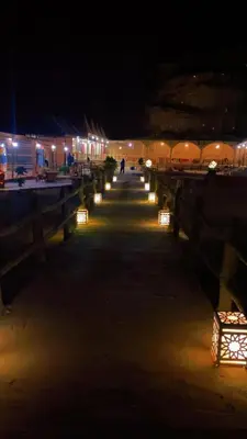 a boardwalk at night with lights on it at Youssef camp Wadi Rum in Wadi Rum