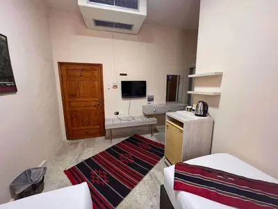 a small room with a kitchen and a living room at Petra fort hotel in Wadi Musa