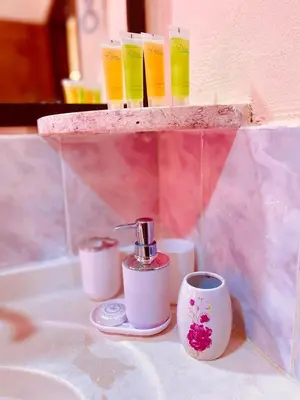 a shelf with three cups and a coffee maker at Petra fort hotel in Wadi Musa