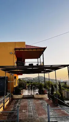 a building with a balcony on top of it at Alreem Farm in Ajloun