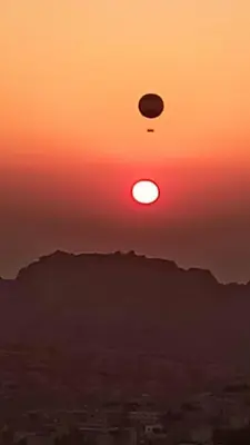 a sunset with a disk in the sky at Grandpa House in Wadi Musa