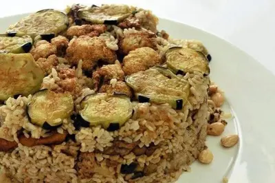 a plate of food with rice and vegetables at Grandpa House in Wadi Musa