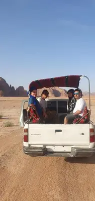 a group of people sitting in the back of a truck at Bedouin experiences in Aqaba