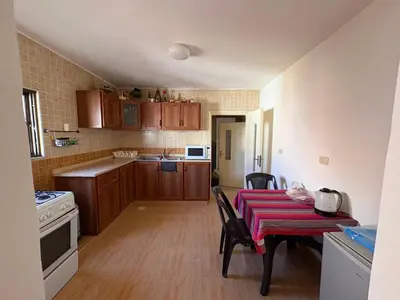 a kitchen with a table with a red table cloth on it at Madaba Hills Apt in Madaba