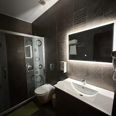 a bathroom with a sink and a toilet and a mirror at La Vie Boutique Hotel in Wadi Musa
