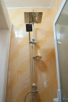 a shower with a shower head in a bathroom at Petra Wow Hostel in Wadi Musa