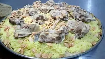 a pan of food with mushrooms on a table at Petra Wow Hostel in Wadi Musa