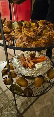 a plate of food with carrots and vegetables on a shelf at Al Namteh Lodge in ‘Ābil