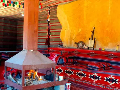 a wood stove with a fire in a room at Wadi rum view camp in Wadi Rum