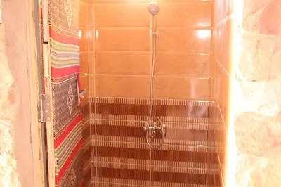 a shower with a hose in a bathroom at Wadi rum view camp in Wadi Rum