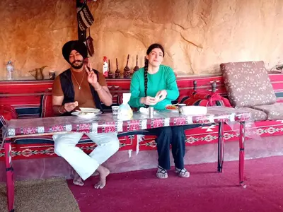 a man and a woman sitting at a table at Wadi rum view camp in Wadi Rum