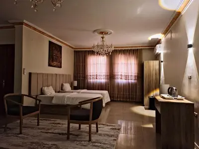 a bedroom with a bed and a table and chairs at Twilight Hotel Petra in Wadi Musa