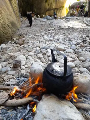 a pot on top of a camp fire at Feynan wild camp in Al Khuraybah