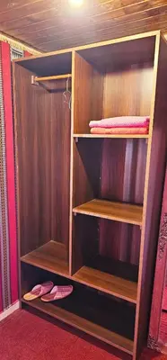 a wooden closet with wooden shelves and shoes in it at Rum Darien Camp in Wadi Rum