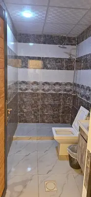 a bathroom with a shower and a toilet at Rum Darien Camp in Wadi Rum