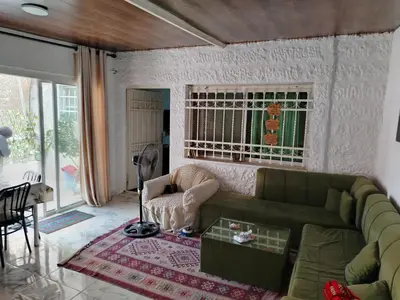 a living room with a green couch and a table at شقه بغرفه وصاله وبلكونه بدون شراكة in Amman