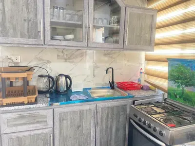 a kitchen with a sink and a stove and cabinets at شقه بغرفه وصاله وبلكونه بدون شراكة in Amman