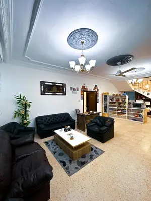 a living room with couches and a coffee table at Panorama Jerash HOTEL (2) in Jerash
