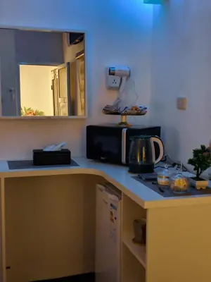 a kitchen with a counter top with a microwave at Panorama Jerash HOTEL (2) in Jerash