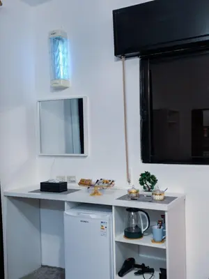 a kitchen with a white counter and a window at Panorama Jerash HOTEL (2) in Jerash