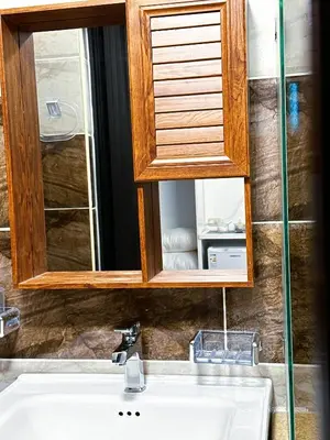a bathroom sink with a medicine cabinet above it at Panorama Jerash HOTEL (2) in Jerash