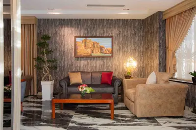 a living room with a couch and a chair at Amman Inn Boutique Hotel in Amman