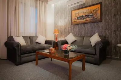a living room with a couch and a coffee table at Amman Inn Boutique Hotel in Amman