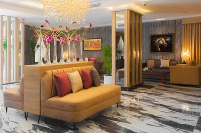 a living room with a couch with pillows on it at Amman Inn Boutique Hotel in Amman