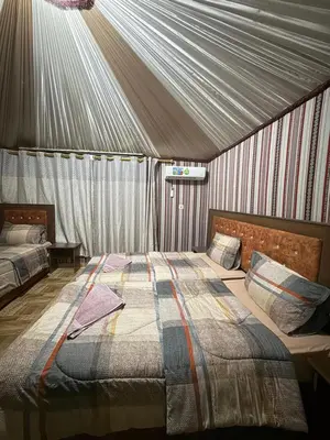 a bedroom with a bed in a tent at Natalie Wadi Rum camp in Wadi Rum