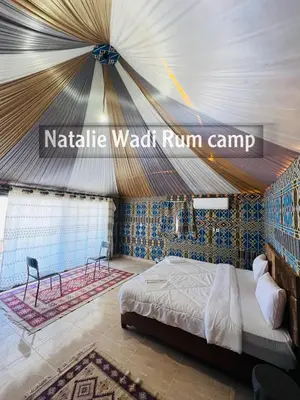a bedroom with a bed in a tent at Natalie Wadi Rum camp in Wadi Rum