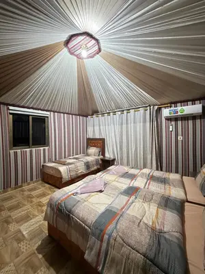 a bedroom with two beds in a tent at Natalie Wadi Rum camp in Wadi Rum