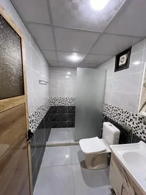 a bathroom with a toilet and a sink at Natalie Wadi Rum camp in Wadi Rum