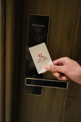 a person is holding a card in a door at Red Carpet Hotel & Suites in Amman