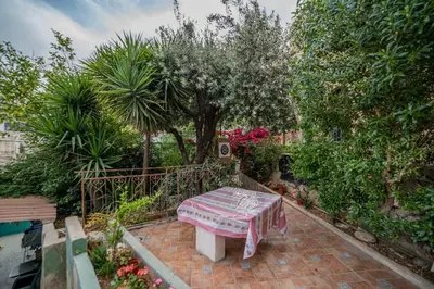 a bench sitting on a brick patio in a garden at Central house with beautiful garden in Amman