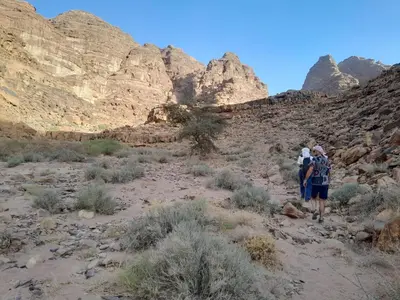 a group of people walking through the desert at Desert Star of Wadi Rum in Wadi Rum