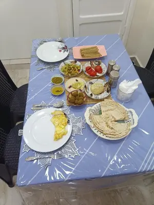 a blue table with plates of food on it at Petra downtown house in Wadi Musa
