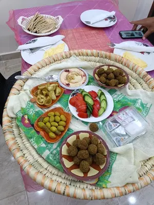 a table with plates of food on top of it at Petra downtown house in Wadi Musa